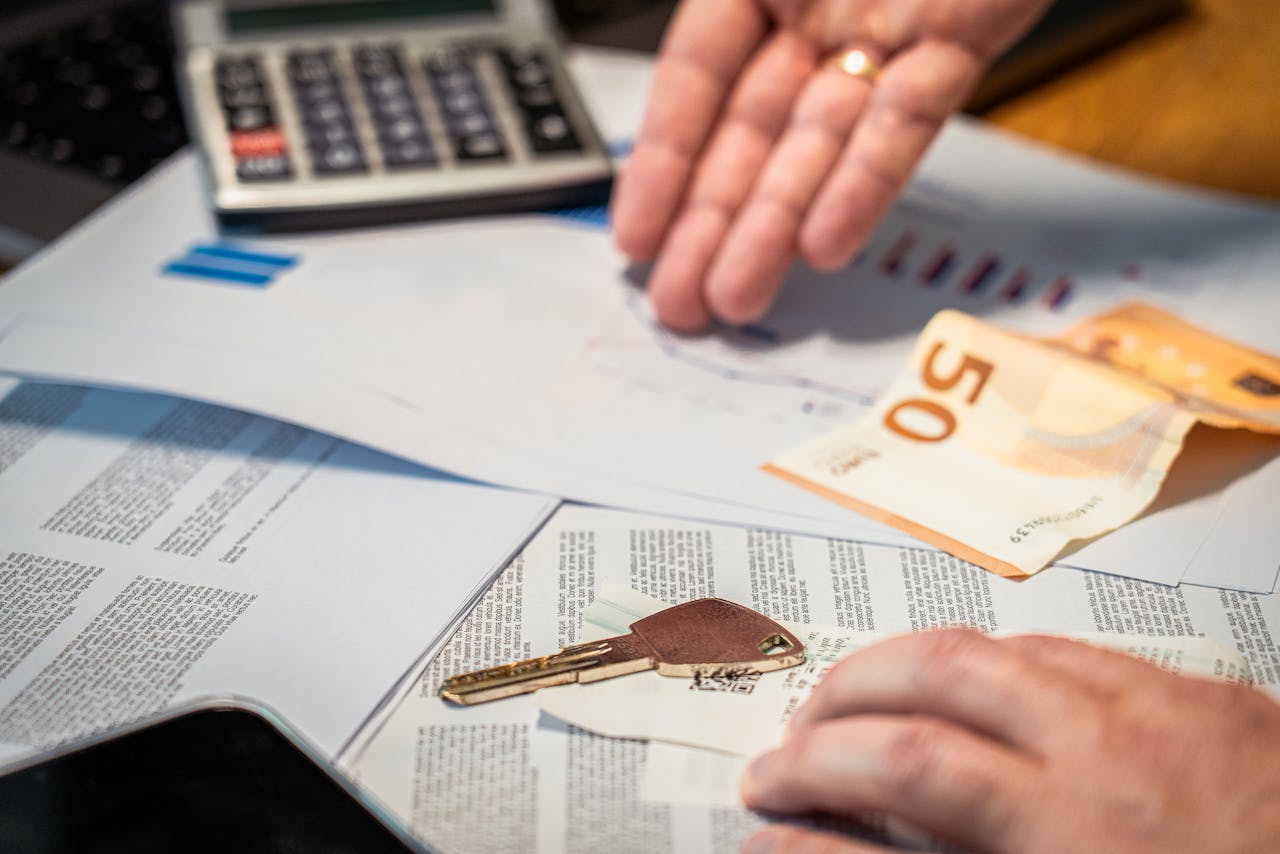 Crafting Captivating Headlines: Your awesome post title goes here Hands examining financial documents, a 50 euro note, and a key, suggesting investment or real estate themes.