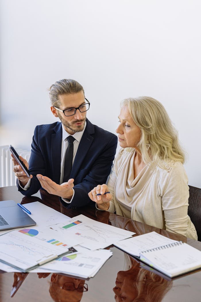 about-02 Professional business discussion between a consultant and client in an office setting.